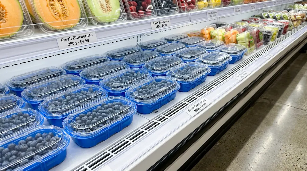 250g blue base clamshell box for blueberries displayed in supermarket refrigerated fruit shelf