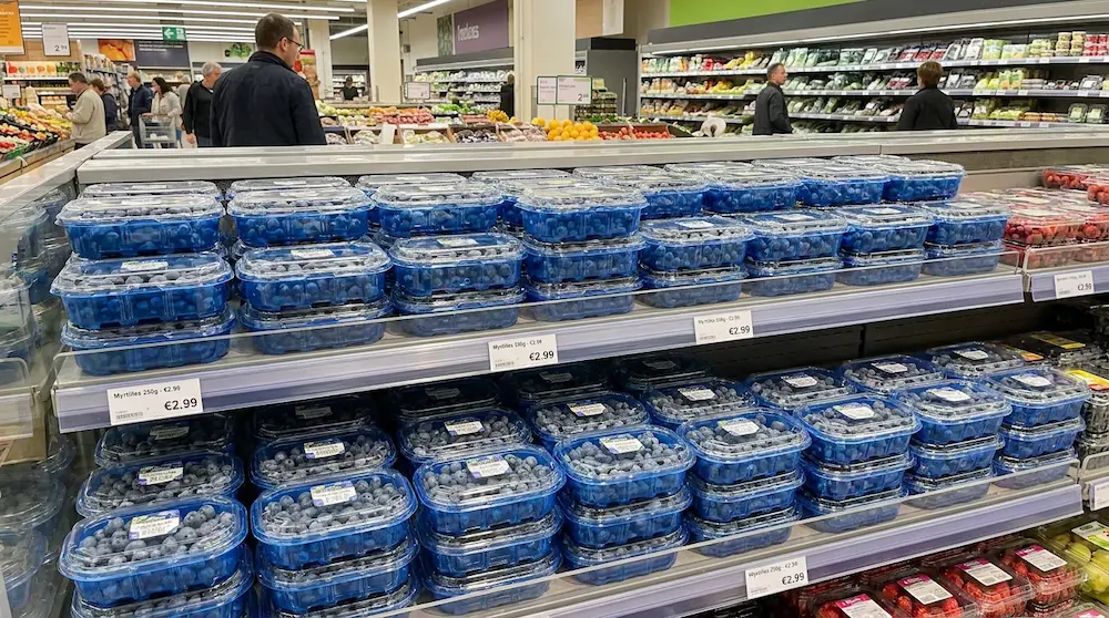 250g blueberry clamshell boxes stacked on European supermarket berry display shelf