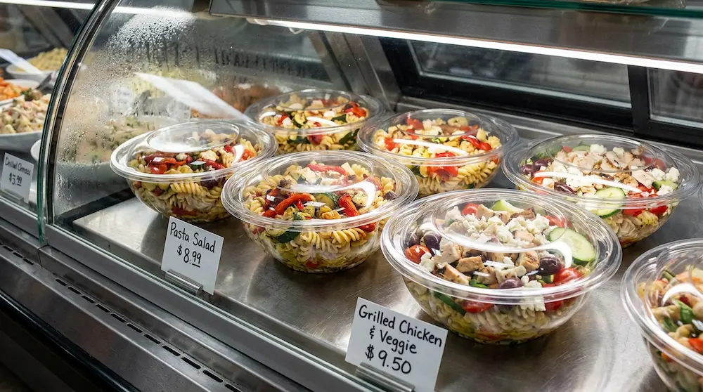 Clear 40OZ PET salad bowl for pasta salad and grilled chicken salad at a deli counter