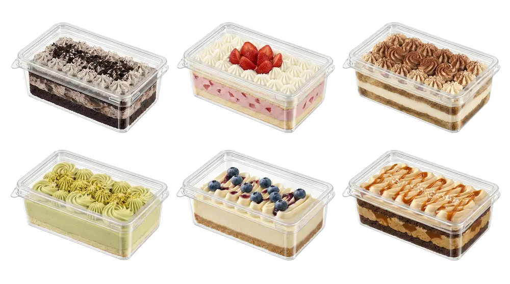 Six clear PET/RPET rectangular dessert containers filled with Oreo cream cake, strawberry cream cake, tiramisu, pistachio cake, blueberry cheesecake, and salted caramel cake.