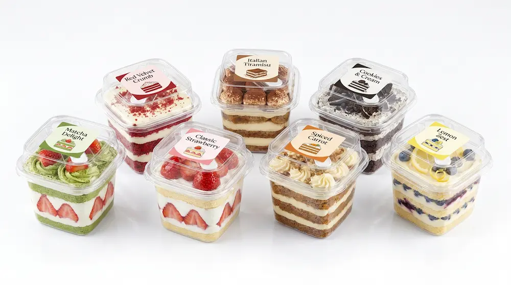 Clear square PET dessert cups with labels for assorted layered cake packaging
