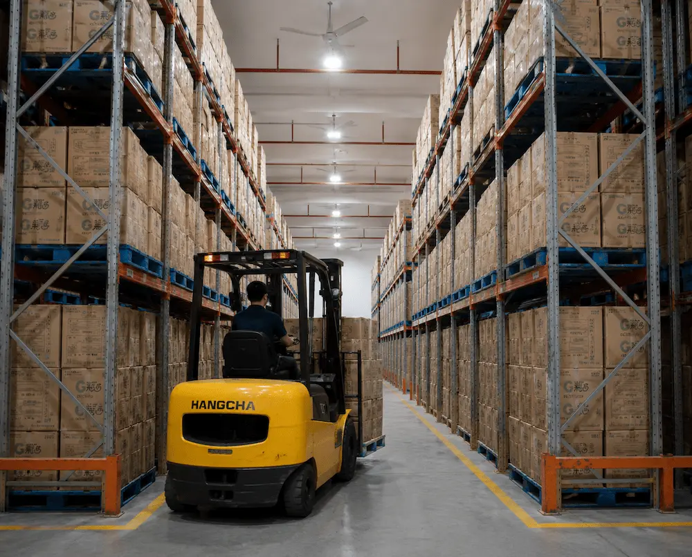 Cold Brew Cups vs Alternative Packaging: How Buyers Should Choose 8 High-density warehouse storage with pallets of packaged cold brew cups and lids, illustrating strong inventory capacity for wholesale beverage supply.