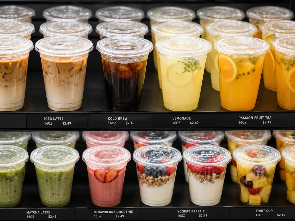 PP cups in supermarket chilled display for iced latte, cold brew, lemonade, fruit cups, and yogurt parfaits