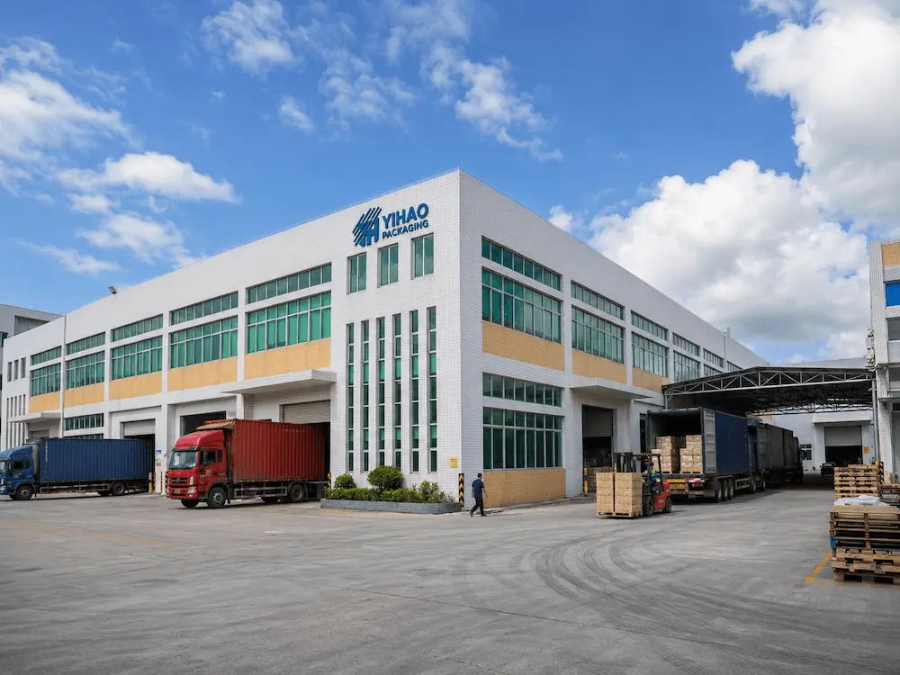 YIHAO Packaging PET coffee cups manufacturing factory exterior with loading trucks