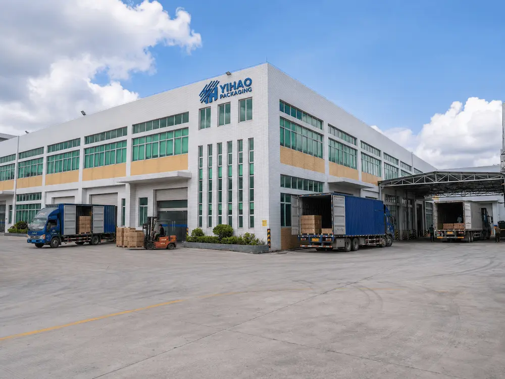 Yihao packaging factory building with loading docks and delivery trucks.