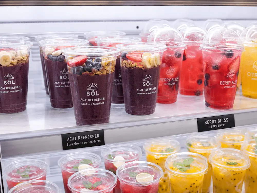 Smoothie, Protein Drink, and Acai Refresher Cups Complete Guide 4 Acai refresher cups and berry refresher cups displayed in a refrigerated grab-and-go shelf