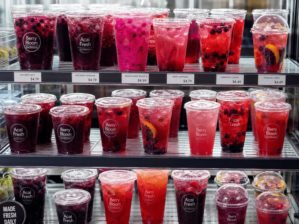 Acai refresher cups in refrigerated retail display for grab-and-go beverages