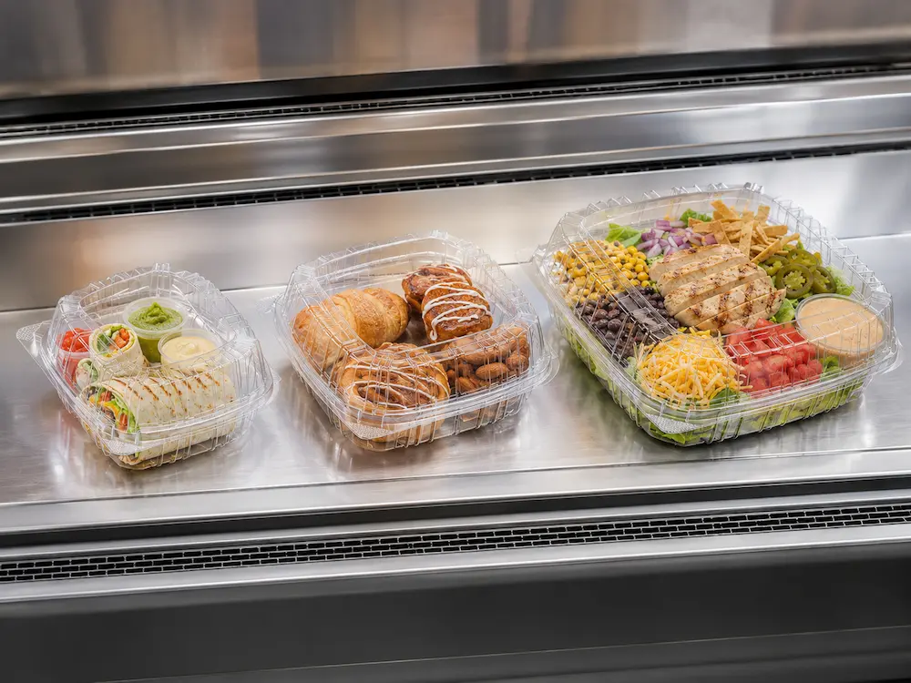 Best Nut Containers for Retail Display, Takeaway, and Chilled Food 8 Clear PET hinged containers used for chilled food display with wraps, bakery items, and salad packs