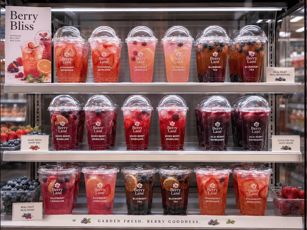 Chilled retail display of berry refresher cups with clear lids and visible fruit ingredients