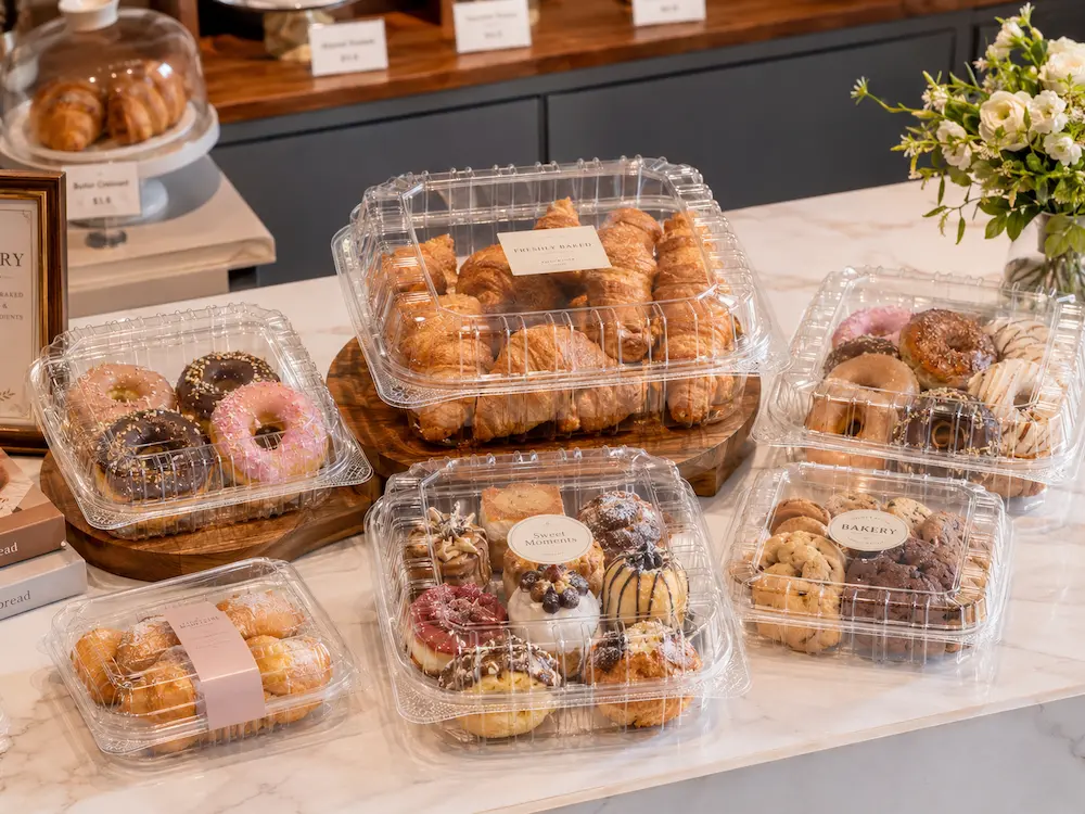 Clear PET bakery clamshell containers for croissants, donuts, cookies, pastries, and dessert assortments