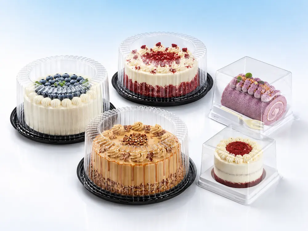 Clear PET cake containers with round dome lids, black bases, and square dessert boxes for bakery packaging