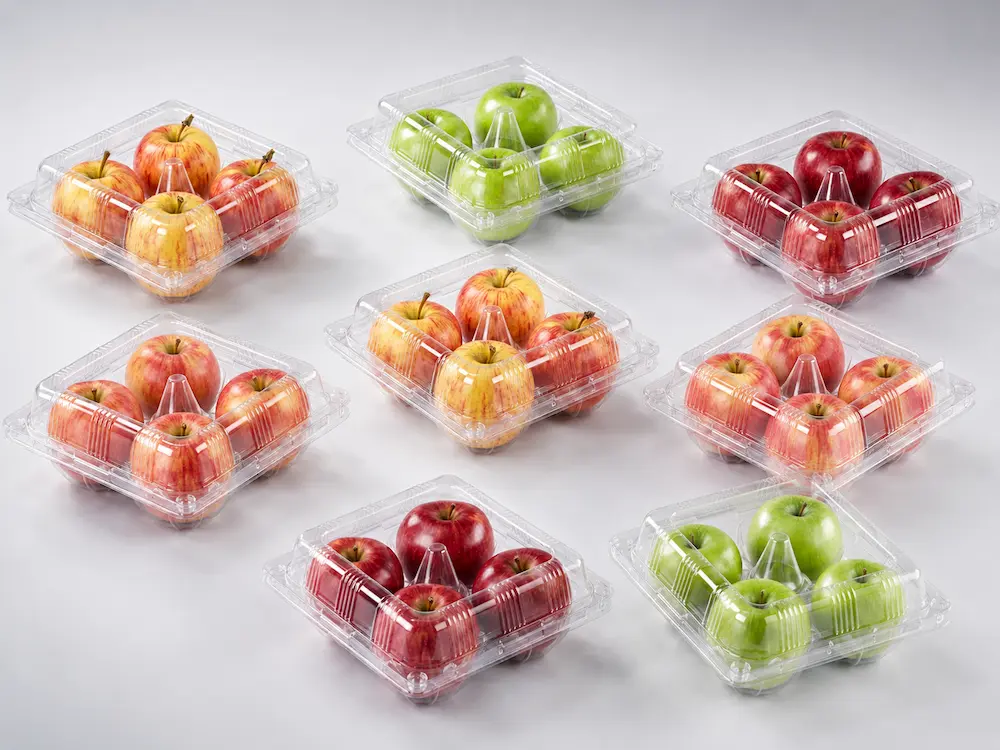 A premium studio composition featuring multiple clear PET fresh produce packaging containers, each holding four apples, arranged on a light cool gray gradient background. The image highlights the transparent PET material, precise container structure, clean retail-ready presentation, and high-end visual appeal for fresh produce packaging applications.