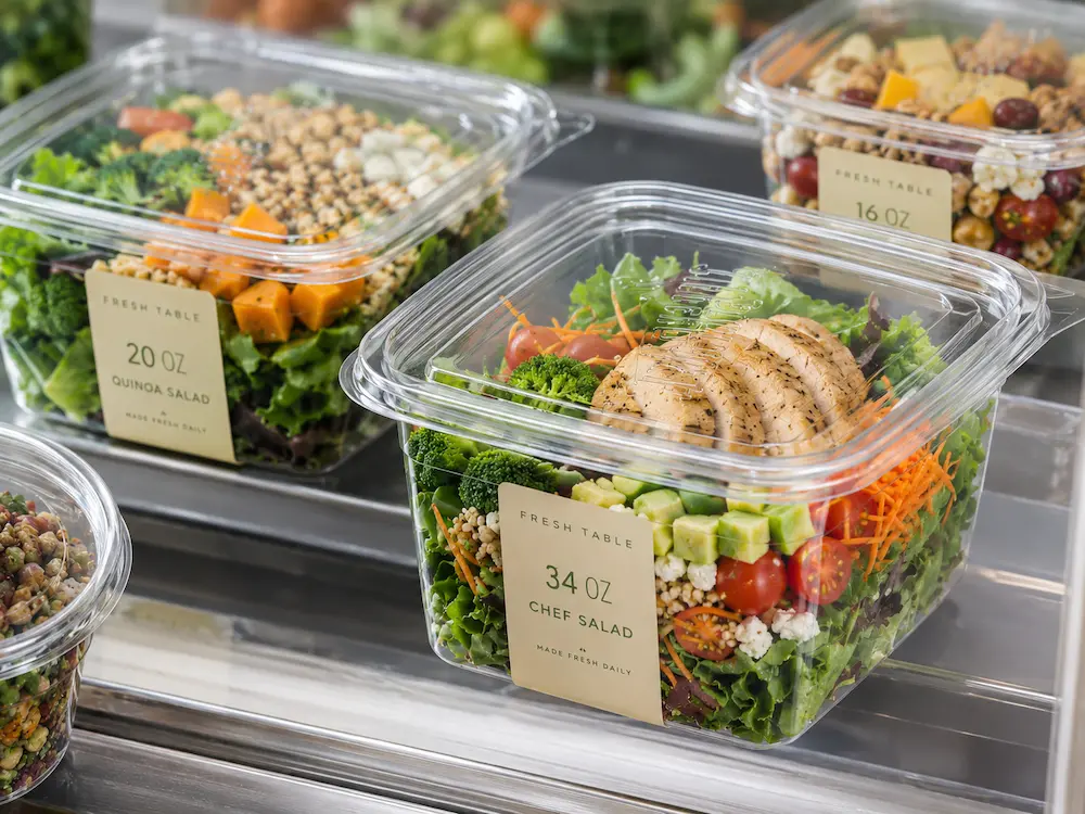 Clear 34 oz square food container filled with chef salad for chilled grab-and-go display