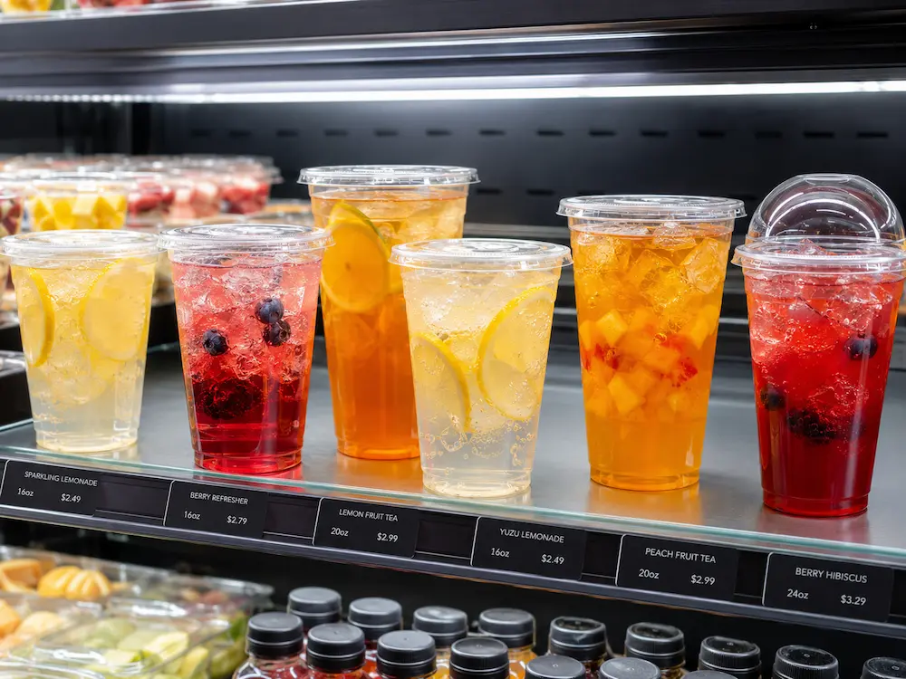 Refresher Cups vs Alternative Packaging: How Buyers Should Choose 2 Colorful refresher drinks in clear PET cups for retail beverage display
