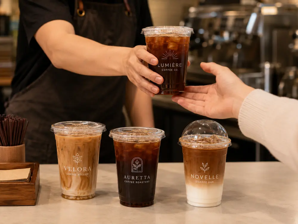 Custom printed cold cups used for iced coffee takeaway service in a cafe