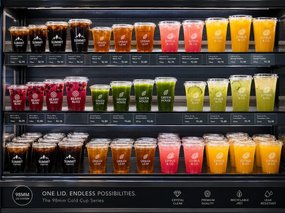 Custom printed cold cups for retail display with clear lids and colorful chilled beverages