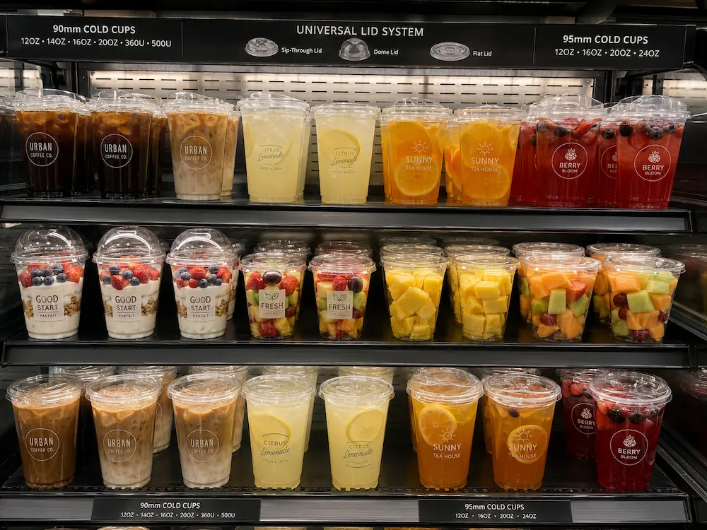Best Cold Cup Supplier for Retail Display, Takeaway, and Chilled Food 4 Retail display cabinet with clear cold cups for iced drinks, fruit cups, yogurt parfaits, and chilled food.