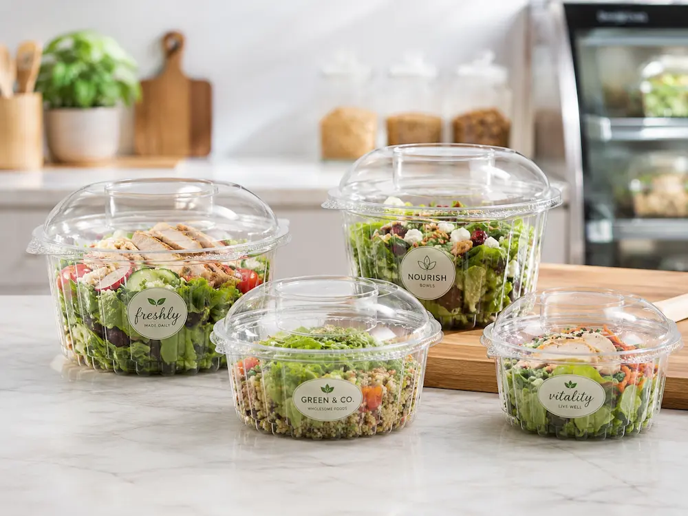Round Deli Containers: Buyer Guide for Food Packaging Teams 2 Clear round deli containers filled with fresh salads and meal prep bowls