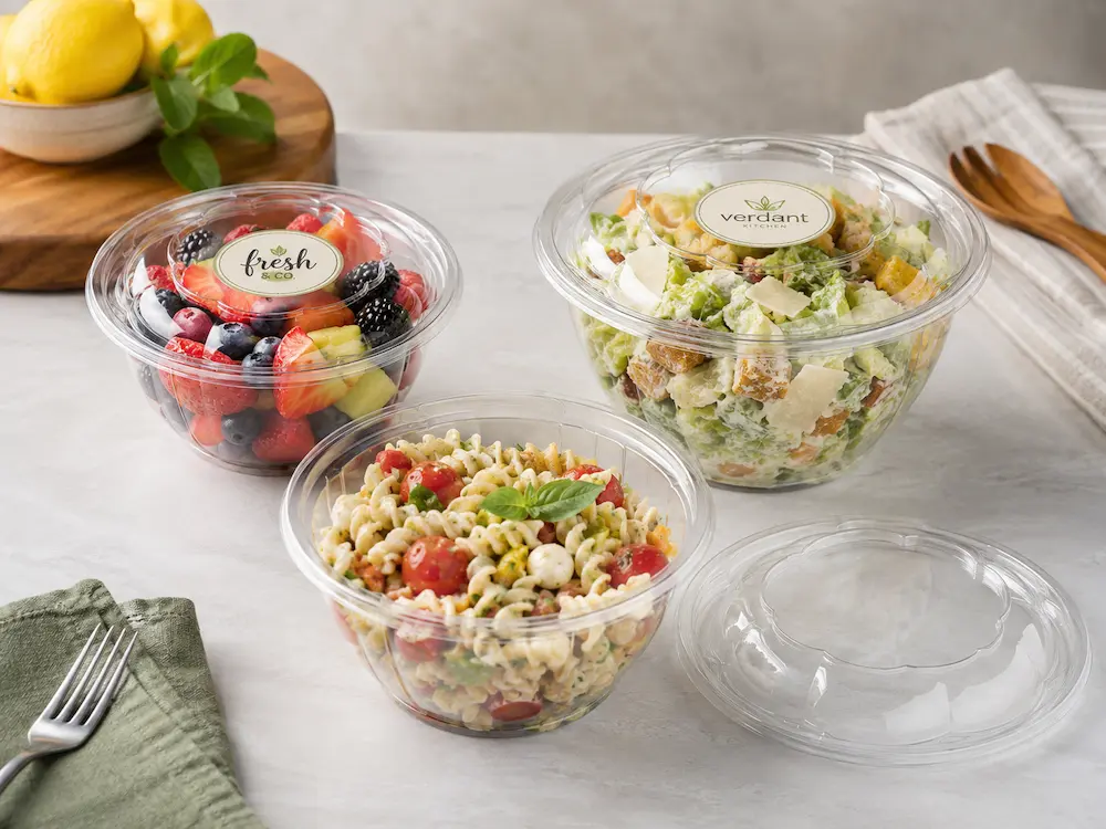 Clear round PET deli containers with fruit salad pasta and separate universal lid