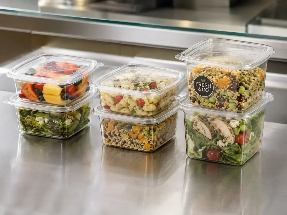 Square PET deli containers filled with salad, fruit, pasta, and grain bowls
