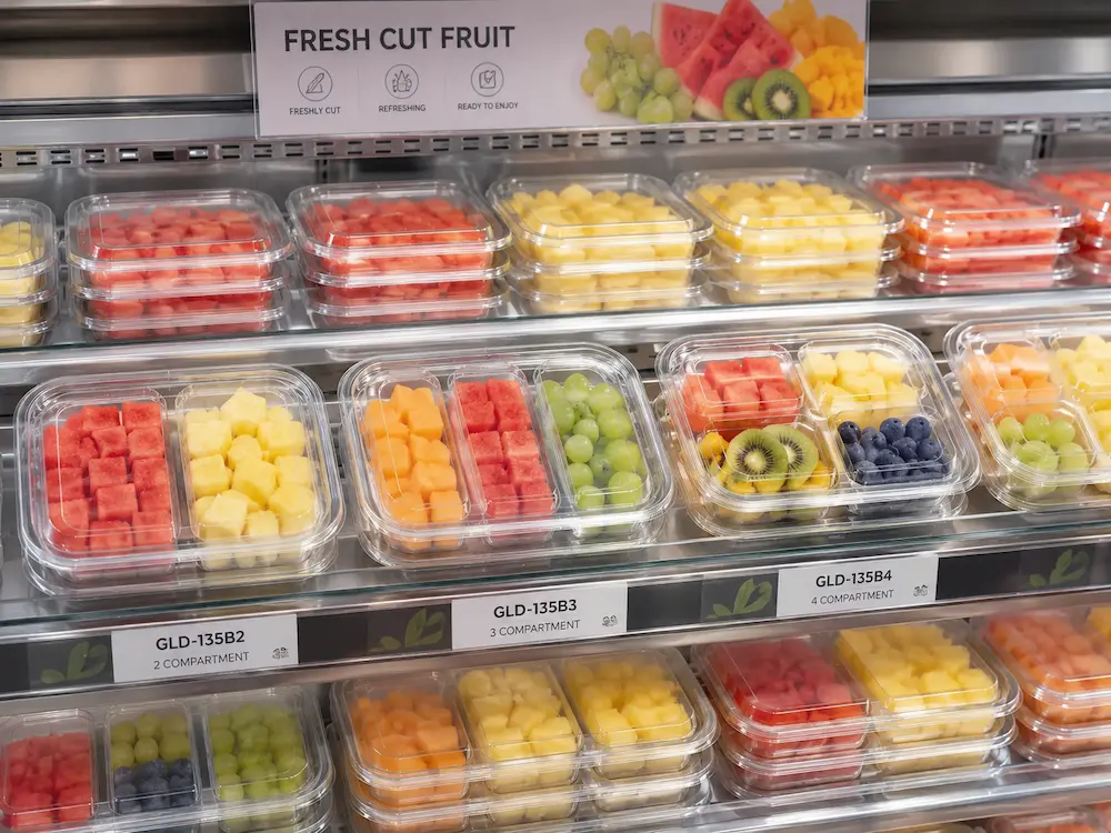 Supermarket chilled fruit packaging display with compartment fruit containers and shelf labels