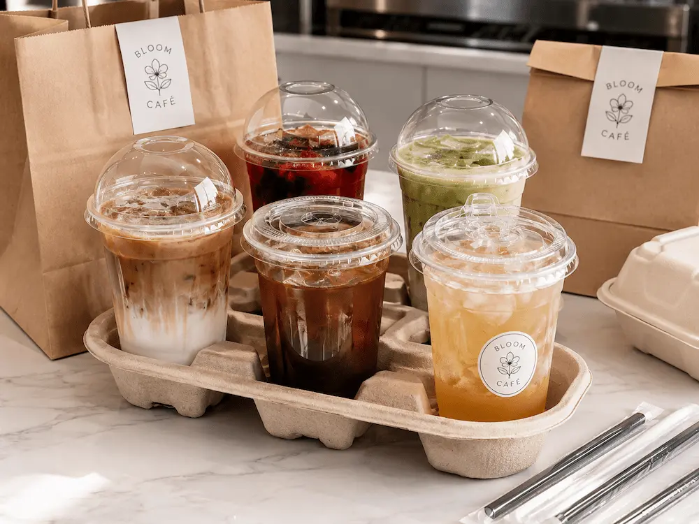 Sealed Drink Cups FAQ: Materials, Sizes, Uses, and Ordering Questions 4 PET sealed drink cups in takeaway drink carrier with dome, flat, and sip-through lids