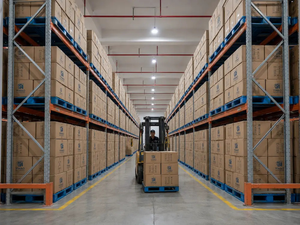 Wholesale Fruit Cup Packaging: Manufacturer and Supplier Checklist 6 Wholesale fruit cup packaging cartons stored in a warehouse with pallets and forklift handling