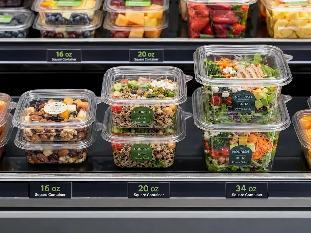 Wholesale square deli containers displayed in a supermarket refrigerated shelf