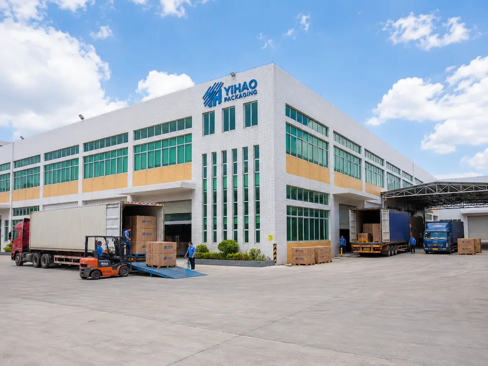 Ready-to-Eat Fruit Containers: Buyer Guide for Food Packaging Teams 8 YIHAO factory exterior with loading trucks for ready-to-eat fruit packaging manufacturing and wholesale supply
