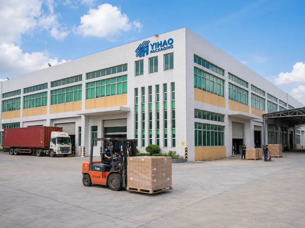 YIHAO packaging factory exterior with loading area, pallets, forklift, and shipping truck