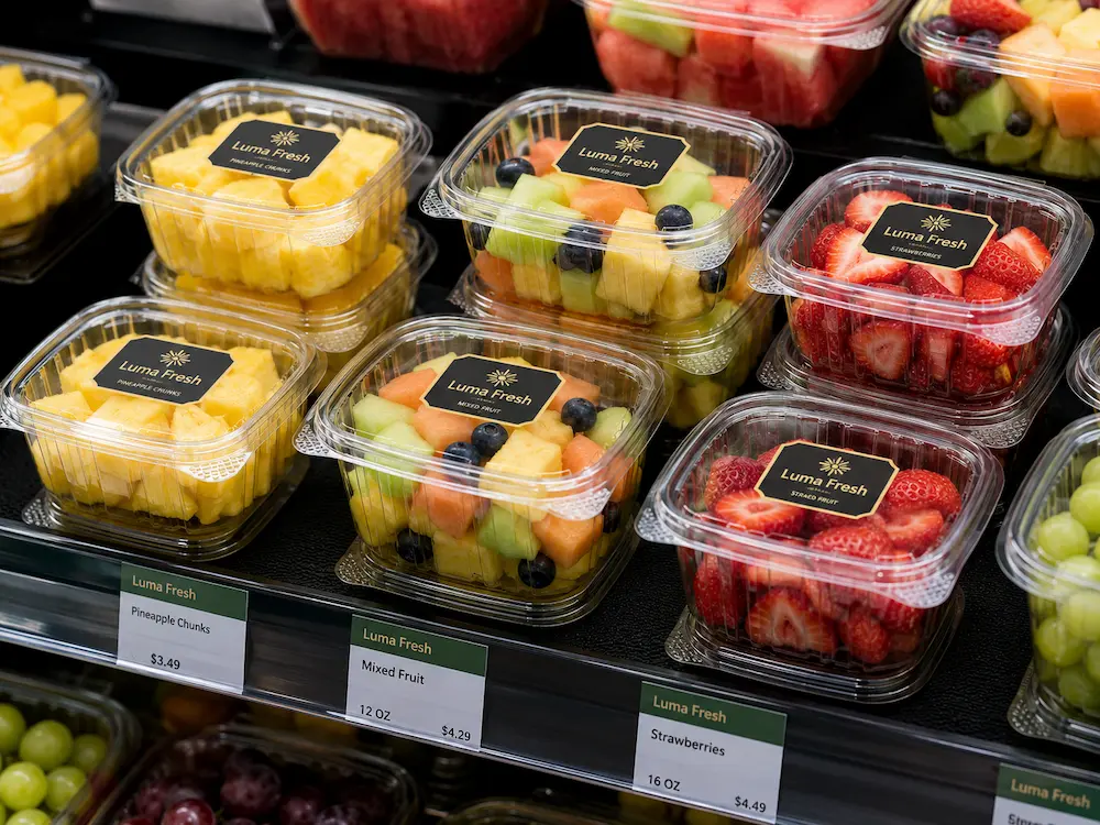 Clear PET hinged fruit containers for refrigerated fresh-cut fruit display