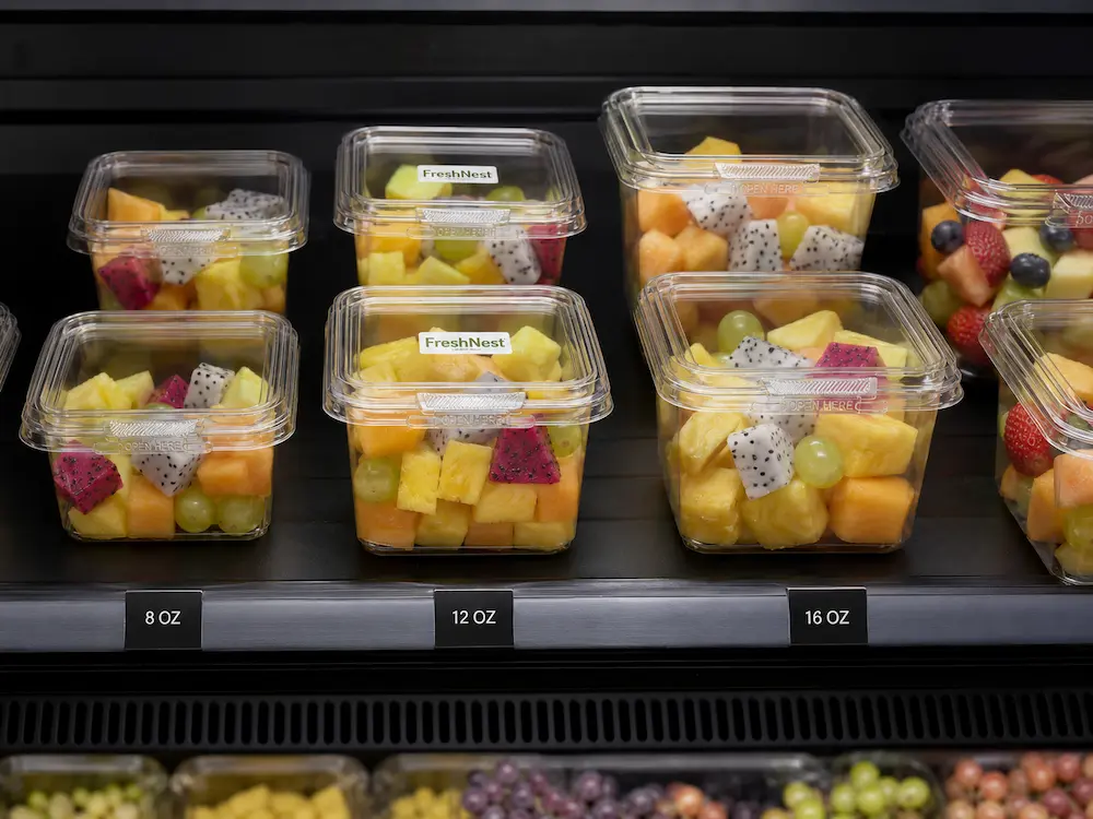 Clear tamper evident fruit containers in a refrigerated retail display