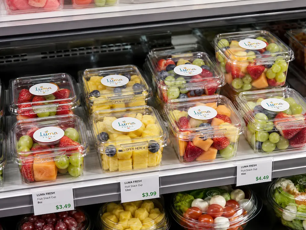 Tamper evident clear PET fruit snack containers displayed in a supermarket cold case