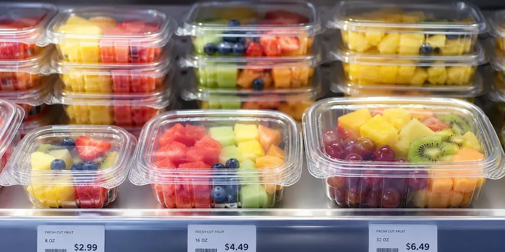 Chilled ready-to-eat fruit containers displayed in a supermarket grab-and-go refrigerator